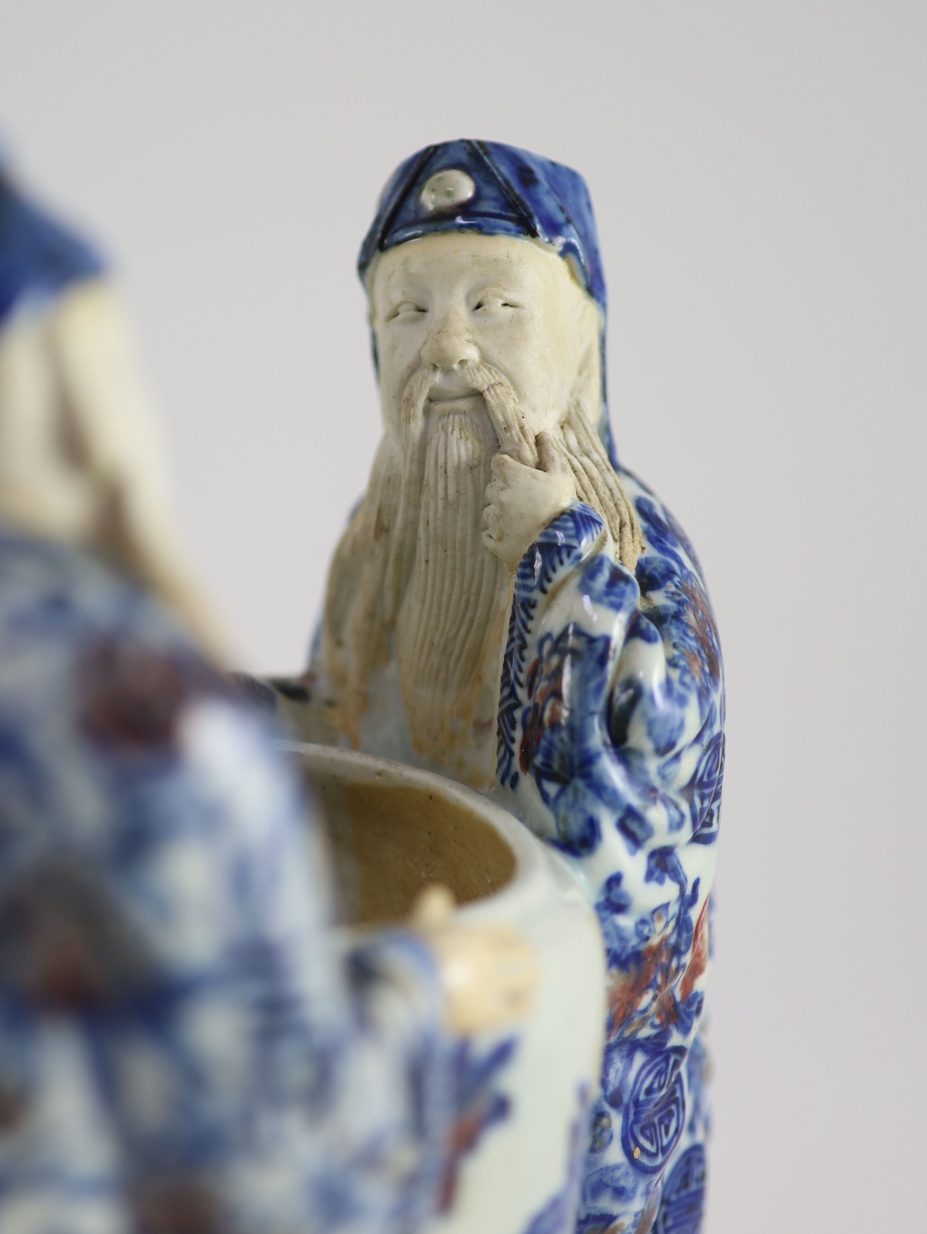 A rare Chinese underglaze blue and copper red porcelain model of the ‘Vinegar Tasters’, Qing dynasty, 26.cm high